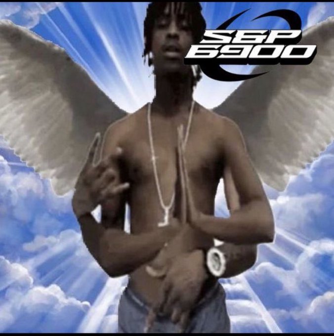 The image features an attractive young man with wings, who appears to be a hipster or artist. He is standing in front of a blue sky filled with clouds, wearing a white shirt and jeans. The background includes a large portion of the sky as well as some clouds. There are also two clocks visible in the scene - one on top of the other. The image seems to be related to an album cover or promotional material for an artist named "SPX RESCUE MISSION".