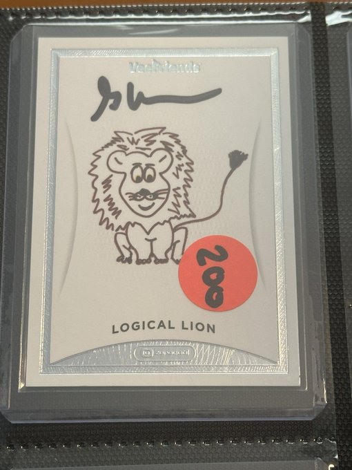 A clear plastic card sleeve containing a white card with a cartoon lion illustration, the number 28 in a red circle, and the text 'Yashinkun', 'ルーレ', and 'LOGICAL LION'.