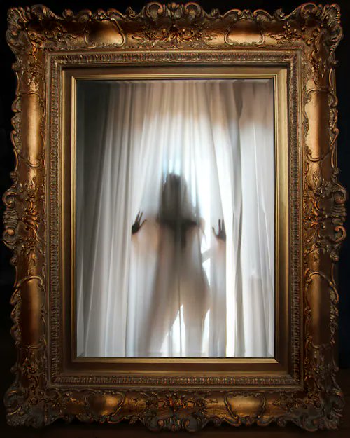 !!!The photo of a person with their face blurred, looking out through a window into another room with curtains or drapes. The reflection can be seen clearly as the curtain is partially open. It seems like there might have been some sort of disturbance outside that caused the person's reflection to appear in this way. I can see the frame and glass elements, but the image does not contain any visible text related to a post on social media. Please note that I cannot provide specific details about the content of the posted photo or its relevance without viewing the original file.