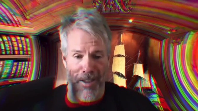 A man with gray hair appears in a distorted, glitch-effect video frame featuring colorful chromatic aberration and a model ship in the background.