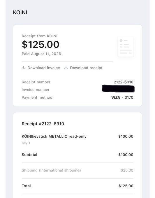 A receipt from KOINI showing a $125.00 payment on August 11, 2026 for receipt #2122-6910, which includes a KŌINIkeystick METALLIC read-only ($100.00) and $25.00 international shipping, paid via Visa ending in 3170—confirming the purchase of the Keystick Metallic device mentioned in the post.