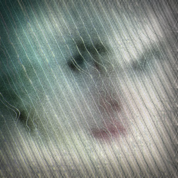 A blurred and glitchy image showing indistinct shapes with streaks of light, with no clear subject visible.