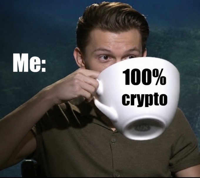 The meme shows a man drinking from an oversized white mug with the text "100% crypto" on it, labeled "Me:" on the left. It humorously depicts someone who, despite others advising only a small crypto allocation, goes all-in by metaphorically "consuming" 100% crypto, exaggerating the typical crypto enthusiast's overcommitment to digital assets.