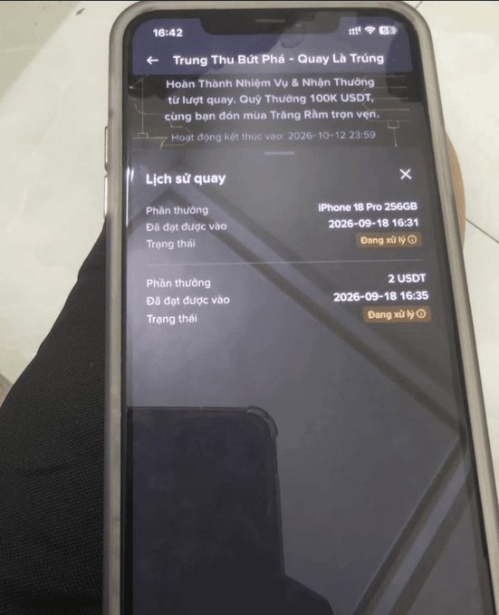A smartphone screenshot of a Vietnamese lottery app ('Trung Thu Bứt Phá') displaying a rewards history that includes an iPhone 16 Pro 256GB and 2 USDT.