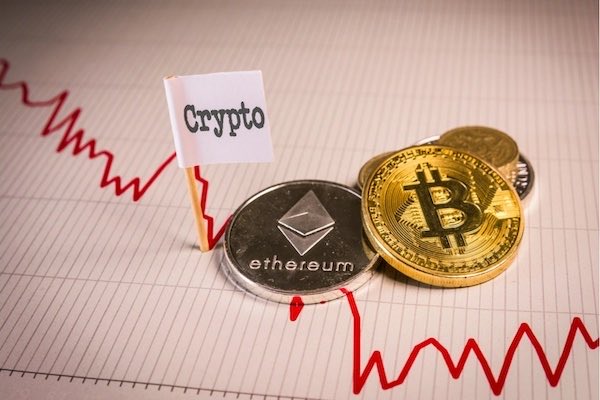 The image shows Bitcoin (BTC) and Ethereum (ETH) coins on a volatile market chart, with a sign labeled “Crypto” and the Ethereum coin marked “ethereum.” It visually accompanies a 24-hour crypto update noting BTC trading around $63,000–$64,000 after a slight recovery.