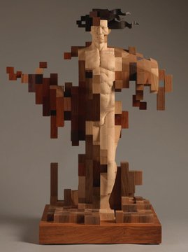 A wooden sculpture of a human figure that appears to be fragmenting or pixelating into individual wooden blocks.