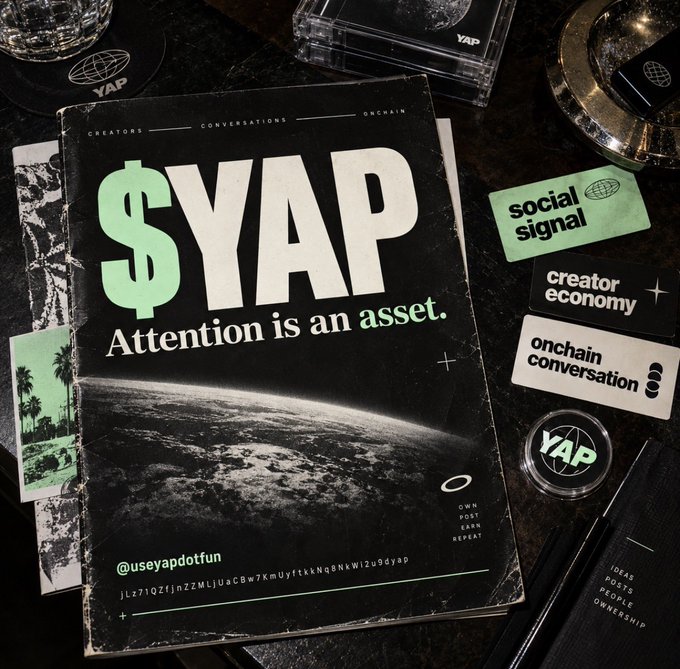 A promotional magazine or zine titled '$YAP - Attention is an asset.' featuring creator economy and social signal branding on a dark table.