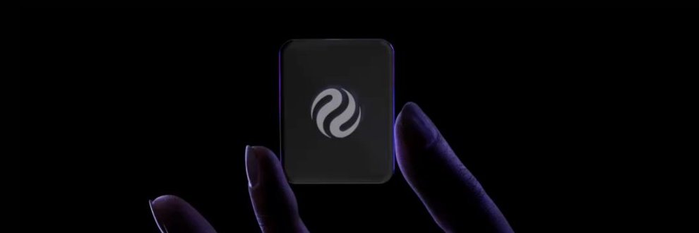 A hand emerges from the darkness against a black background, holding up a smartphone displaying the Injective logo (a swirling "INJ" symbol), visually representing the project as the post announces native privacy technology being developed for Injective's Layer 1 blockchain.