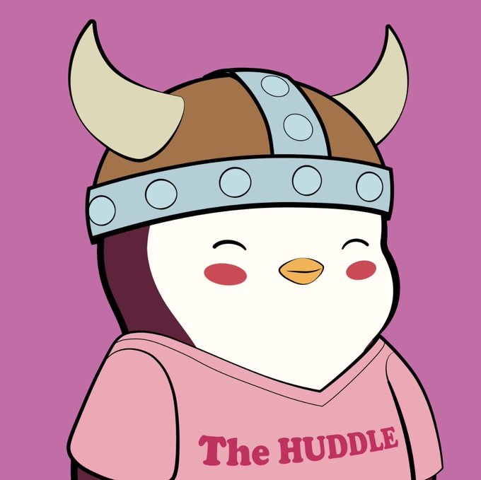 A cartoon penguin wearing a brown and grey Viking helmet and a pink shirt that reads 'The HUDDLE' against a pink background.