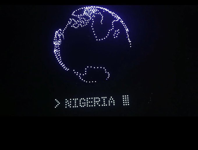 A pixelated blue dot-matrix display featuring a globe icon with a cursor pointing to "NIGERIA" in a menu list, viewed in a dark setting that complements the retro-tech aesthetic referenced in the "Sleek!" caption.
