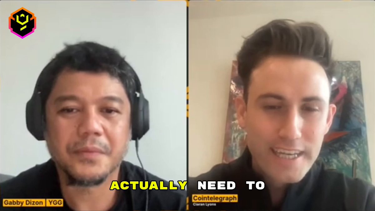 The image shows two men wearing headphones sitting next to each other with their faces displayed side by side. The man on the left has a serious expression while the one on the right appears to be smiling. They are both wearing black t-shirts, which adds to the casual and relaxed atmosphere of the scene.