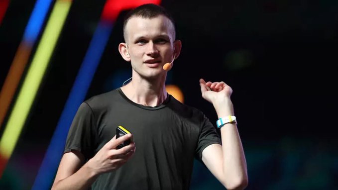 A young man with short hair wearing a dark t-shirt and headset microphone gestures while speaking on stage, likely Vitalik Buterin presenting Ethereum's future vision of parallel processing with cryptographic proofs.