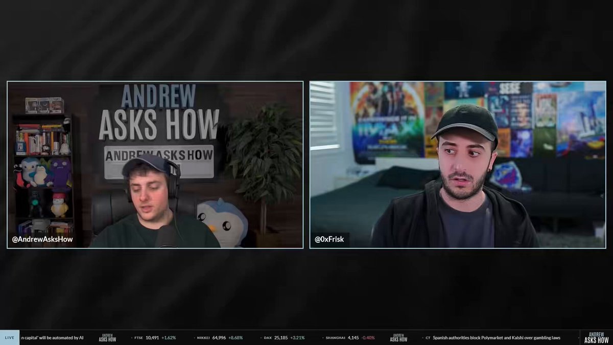The image shows two men sitting at their computers with headphones on, appearing to be engaged in an online video call or a live stream. The man on the left side of the screen has his head tilted back while the other man looks directly into the camera. Both individuals are wearing hats and have microphones attached to their devices, indicating that they might be participating in a podcast or a live streaming event.