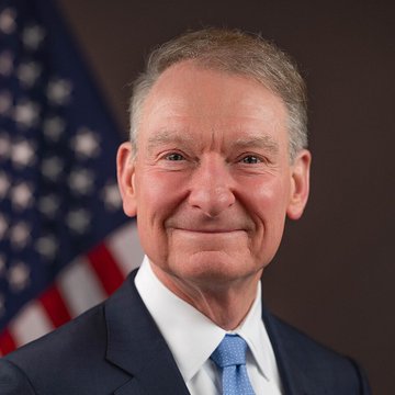 SEC Chair Paul Atkins, pictured before an American flag, has announced that the Securities and Exchange Commission will move forward with cryptocurrency regulations independently of the CLARITY Act.