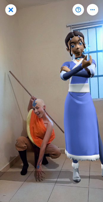 This image shows a person dressed as Aang alongside a digital collectible of Katara, celebrating the first trailer of Avatar: The Last Airbender. The Augmented Reality overlay from VeVe is visible.