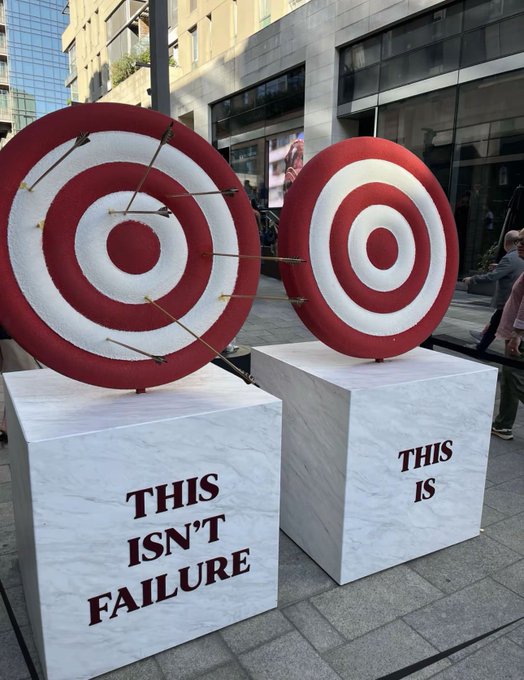 The image features two red targets with white bullseyes mounted on a white block. The targets are positioned side by side, creating an interesting visual contrast between the traditional target design and the modern approach of focusing on Quantum resistance Compute infrastructure and cross-chain interoperability in the future.