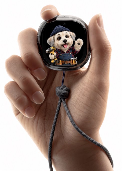 A hand holds a small square smartwatch displaying a cute cartoon puppy wearing a blue cap and overalls, with a gray lanyard cord attached.
