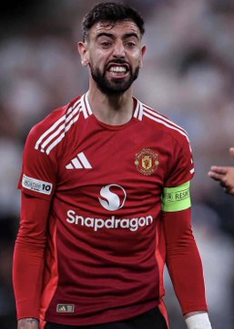 A Manchester United player, wearing a red kit featuring the "Snapdragon" sponsor logo and captain's armband, grimaces with an intense expression during a match. The image connects to the post by highlighting the uncertainty surrounding the team's performance, as a $42,000 bet has been placed against them winning their upcoming fixture against Hull City.