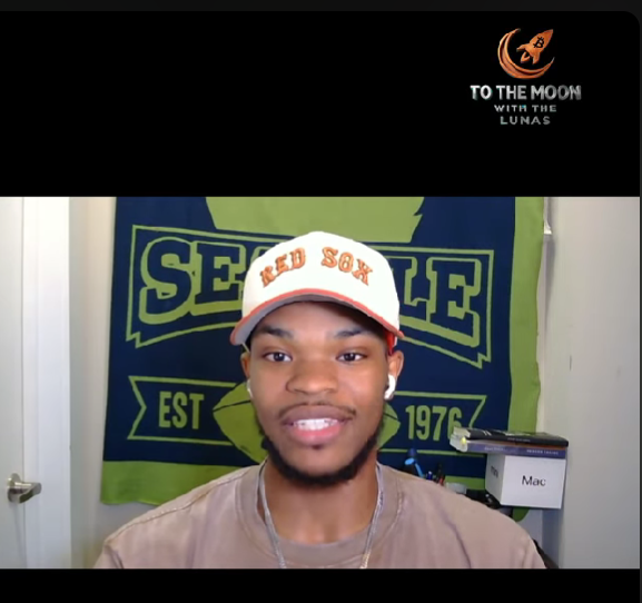 A young man wearing a Red Sox cap speaks in a video, with a 'To The Moon with The Lunas' logo featuring a rocket in the top right corner.