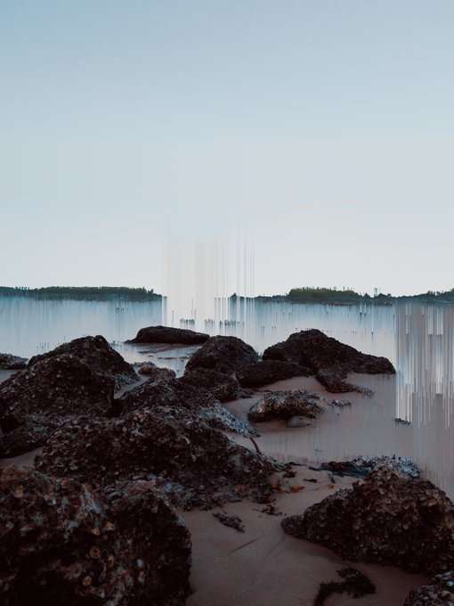 A rocky shoreline at twilight with a glitchy, distorted horizon line cutting through the scene, evoking the corrupted digital artifact referenced in the sale of Corrupted Capsule #12. The pixelated streaks across the water mirror the "corrupted" theme of the NFT being celebrated in the post.