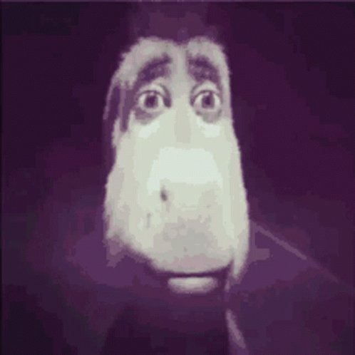 The image features a cartoon-like face with big eyes, giving it a creepy appearance. The background of the image is dark purple, which further emphasizes the unsettling nature of the scene. In the bottom right corner of the photo, there's a caption that reads "come on bro send it without me wallahi im finished". This caption seems to be related to the image or the post in some way, but its exact connection cannot be determined from the available information.