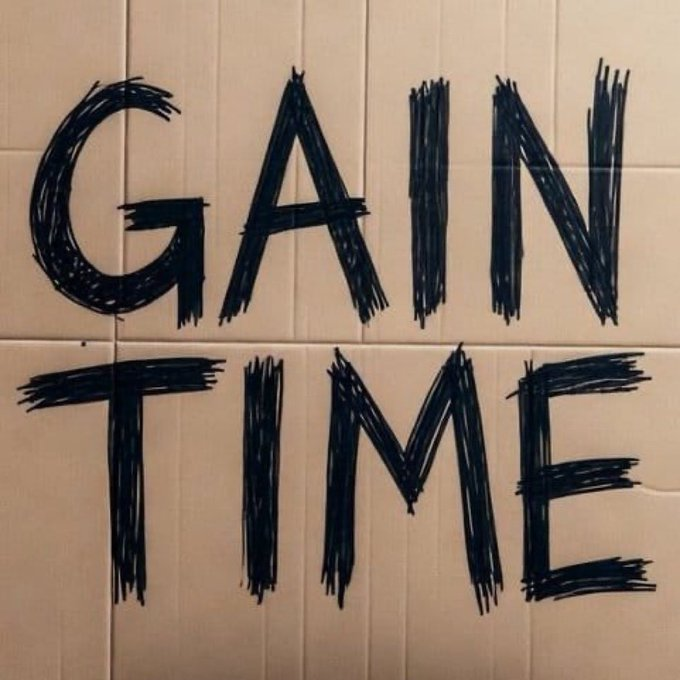 The phrase 'GAIN TIME' written in large, rough black marker strokes on light-colored tiled walls.