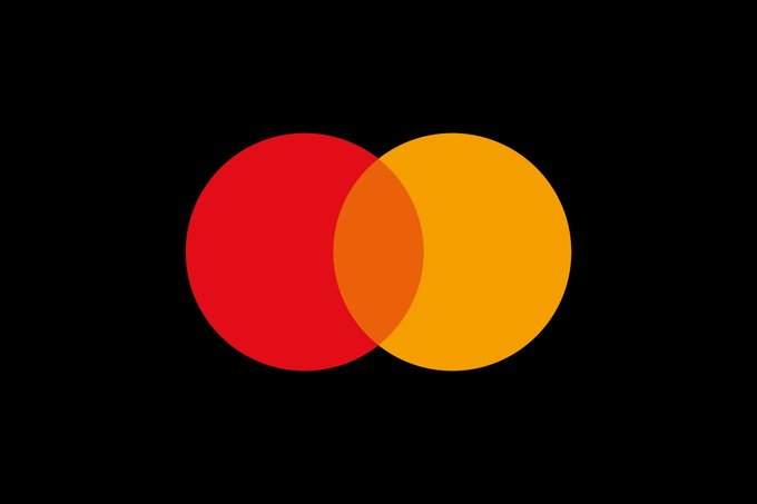The image features a logo for Mastercard and Chainlink, which are two companies that provide digital payment solutions. The logo consists of two overlapping circles, one red and one yellow, set against a black background. The text "Mastercard and Chainlink" is written below the logo, indicating the partnership between these two companies to enable users to purchase crypto on their respective platforms.