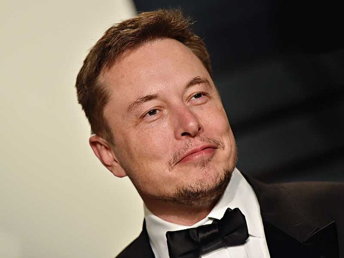 Elon Musk, wearing a black tuxedo with bow tie, is shown in a close-up portrait with a slight smile. The image relates to the post as it features Musk, the SpaceX and Tesla CEO whose two companies will now both be part of the Nasdaq-100 index.