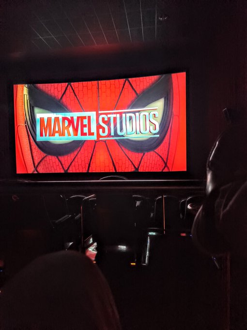A movie theater screen displaying the "MARVEL STUDIOS" logo, signaling the start of a film, as audiences settle in for the show. A perfect "gm" (good morning) for fans ready to kick off their day with some superhero action.