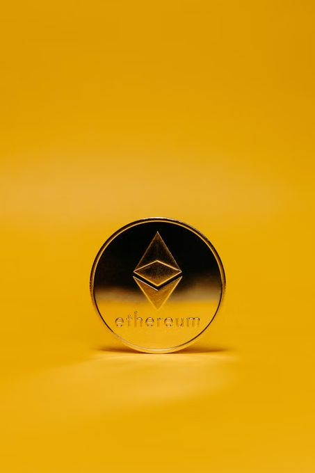 A golden Ethereum coin stands upright against a matching yellow background, displaying the "ethereum" text and its iconic diamond-shaped logo. The image's bold gold aesthetic and prominent Ethereum branding visually reinforce the post's message about significant whale activity involving $ETH.