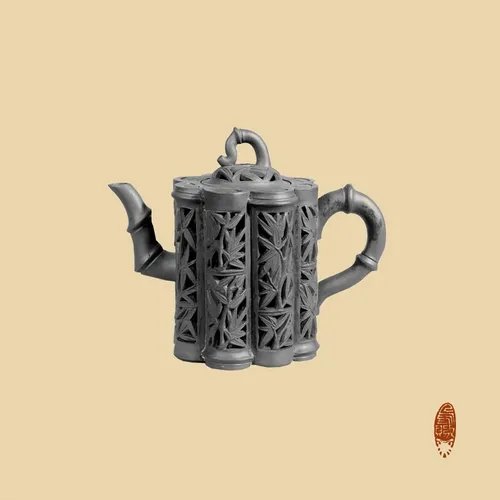 A dark gray, intricately carved teapot with a lattice pattern sits against a solid pale yellow background, with a small red seal visible in the bottom right corner.