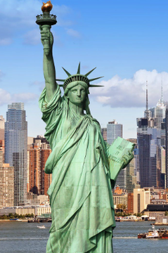 The Statue of Liberty stands tall against the backdrop of the New York City skyline, symbolizing the state's stance as New York Attorney General Letitia James sues Polymarket for alleged illegal gambling operations under state laws.