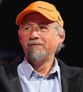The image features a man wearing an orange hat with the word "MILTON" printed on it. He has a beard, glasses, and appears to be a professional or expert in a field related to the cryptocurrency industry. The man is also dressed in a blue collared shirt, which may suggest that he works at a company or is associated with a specific organization or event. The image includes text about Adam Back's research on Bitcoin over the next two years, indicating an ongoing project or topic of interest within the crypto community.