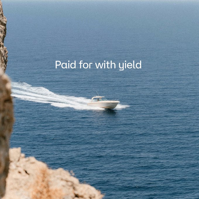 A speedboat cruises across blue ocean water near a rocky cliff, with the text 'Paid for with yield' overlaid.
