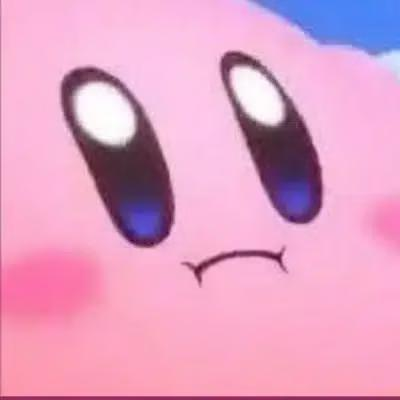 A close-up of a pink cartoon character, recognizable as Kirby, with large oval eyes and a small mouth.