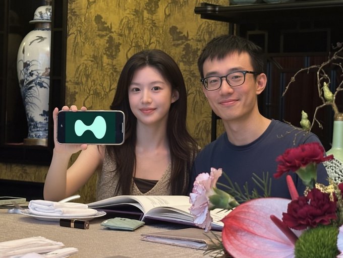 A young woman holds up a phone displaying a green "H" logo, seated beside a smiling man wearing glasses at a table with flowers and a menu in an elegant restaurant setting. The post celebrates accumulating 10,000 $HYPE coins, and the image shows two people posing with the Hyperliquid "H" symbol, likely marking a milestone in their token holdings.