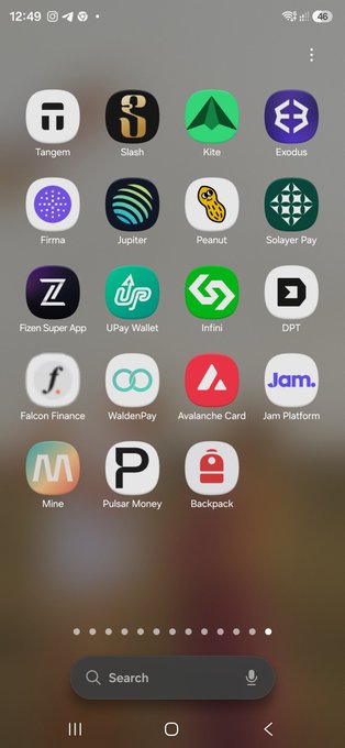 A smartphone home screen displaying various cryptocurrency and finance app icons including Tangem, Kite, Exodus, Firma, Jupiter, Peanut, and Solana Pay.