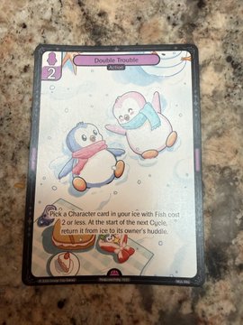 A trading card titled 'Double Trouble' featuring two cartoon penguins in winter scarves, with the text instructing to 'Pick a Character card in your Ice with Fish cost 2 or less.'