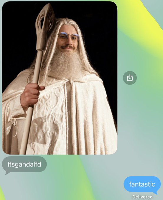 A photo of a man dressed as Gandalf with a white robe, long white beard, and staff, shared in a chat from user 'itsgandalfd' with the reply 'fantastic'.