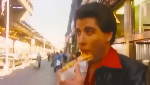 The image shows a man eating pizza while standing on a street, with several people walking by him. The scene appears to be from an old movie or TV show, as there are elements of nostalgia present. The caption reads "algo is nuked monetization is paused no new meta in sight my girl left me too is it over for me?". This phrase suggests that the image might have been taken during a time when people were more focused on their personal lives and relationships rather than digital content or online trends, which could be related to the nostalgic atmosphere of the scene.