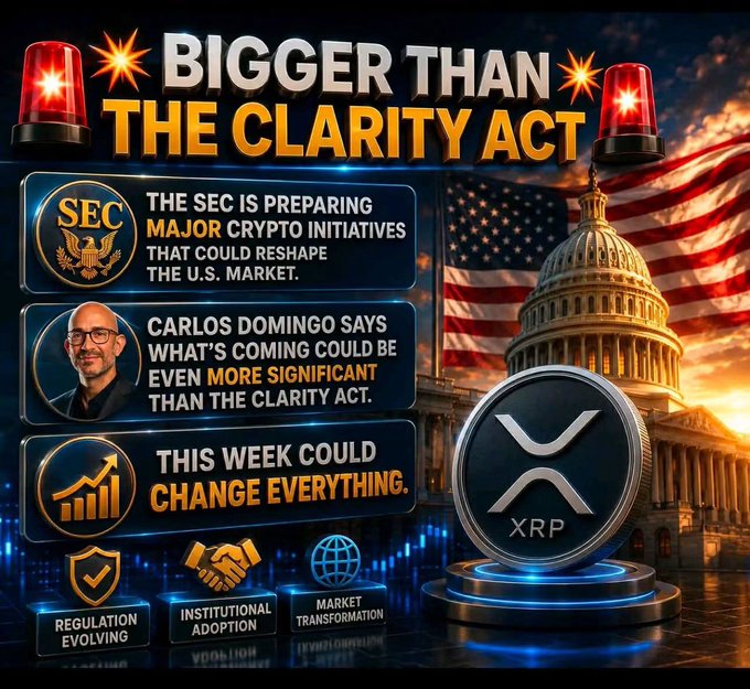 A promotional graphic titled 'BIGGER THAN THE CLARITY ACT' featuring an XRP coin, the U.S. Capitol building, and text mentioning 'THE SEC IS PREPARING MAJOR CRYPTO INITIATIVES' and a quote attributed to 'CARLOS DOMINGO'.
