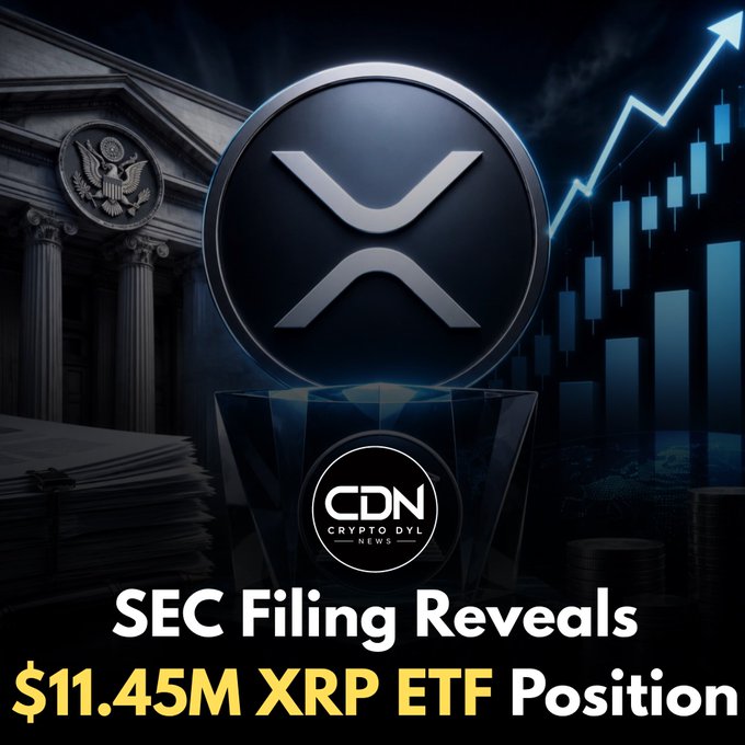 The image is a Crypto DVL News (CDN) graphic featuring a large XRP coin logo set against a backdrop of a government building (with an eagle seal), financial documents, and an upward-trending stock chart, with bold text reading "SEC Filing Reveals $11.45M XRP ETF Position." The visual ties directly to the post by combining regulatory imagery (SEC/gov building, paperwork) with XRP branding and bullish market charts to emphasize the significance of the disclosed $11.45M XRP ETF position.