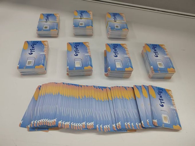 Numerous stacks of "CTExcel" SIM cards are arranged on a white surface, representing the British Telecom CTExcel Classic Plan being promoted as an alternative to Giffgaff amid account bans. The image showcases the bulk inventory of these prepaid SIMs, advertised at 205 yuan with 15GB annual data, 20 Dogecoins, and £50 activation cashback.