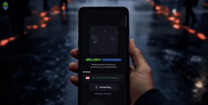 A Beldex Browser advertisement showing a hand holding a smartphone displaying the "BELDEX BROWSER" connecting screen against a dark, rainy city background.