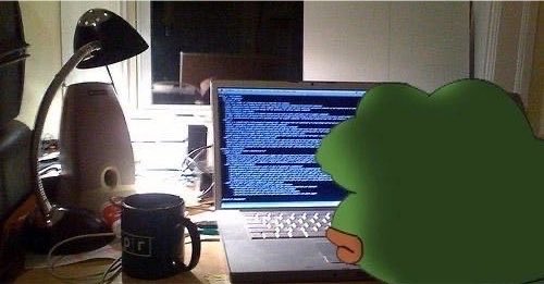 A person sits at a desk with a laptop displaying code, illuminated by a desk lamp, with a coffee mug nearby; their face is obscured by a green cartoon tree graphic.