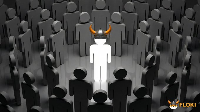 The image features a large group of people standing around each other with their heads down. In the center of this gathering, there's a person wearing an orange hat that has a horn on top, giving them a unique appearance. The background of the image is black and white, which contrasts with the colorful figure in the foreground. The caption to the image reads: "No matter what they say, no matter how markets turn Never give up on $FLOKI".