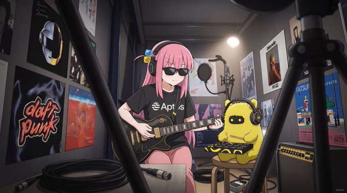 An anime-style character with pink hair and sunglasses plays an electric guitar alongside a small yellow creature wearing headphones in a music studio decorated with "Daft Punk," "Bloc Party," and "Tatsuro Yamashita" posters, while her t-shirt prominently displays the "Aptos" logo — visually tying the Aptos blockchain branding mentioned in the post to a creative, always-on studio aesthetic that mirrors the 24/7, onchain trading lifestyle promoted by DecibelTrade.