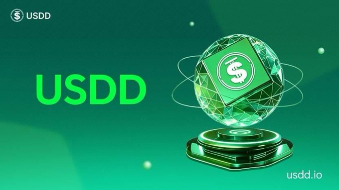 A vibrant green promotional graphic features the "USDD" ticker logo in the top-left corner and displays "USDD" in bold green text alongside a 3D crystalline sphere bearing the USDD dollar emblem, set on a glowing futuristic pedestal with "usdd.io" in the bottom-right—visually reinforcing the post's message about converting volatile crypto into the USDD stablecoin as a safe haven during market turbulence.