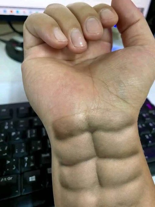 A close-up of a clenched fist held over a black computer keyboard, showing prominent veins on the back of the hand and wrist.