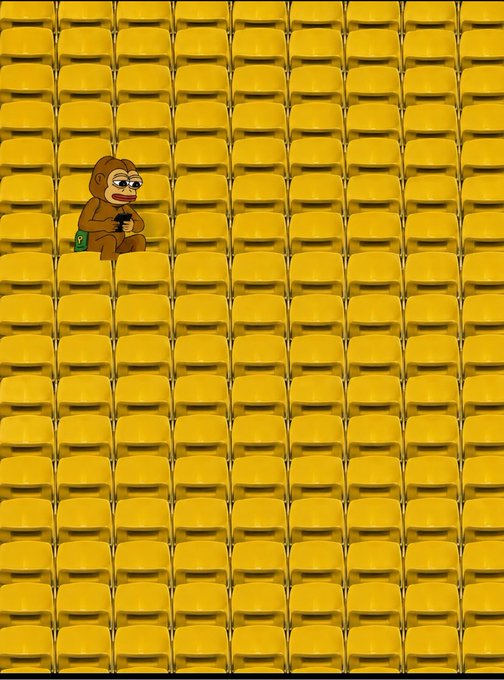 A meme illustration of a sad monkey holding a phone, sitting alone among rows of empty yellow stadium seats.